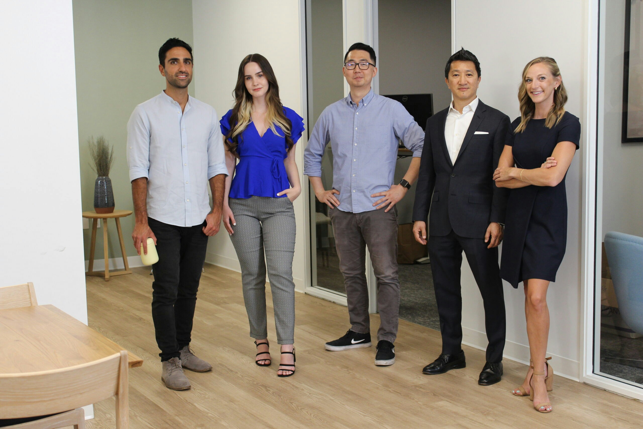 More colleagues standing next to each other in an office.