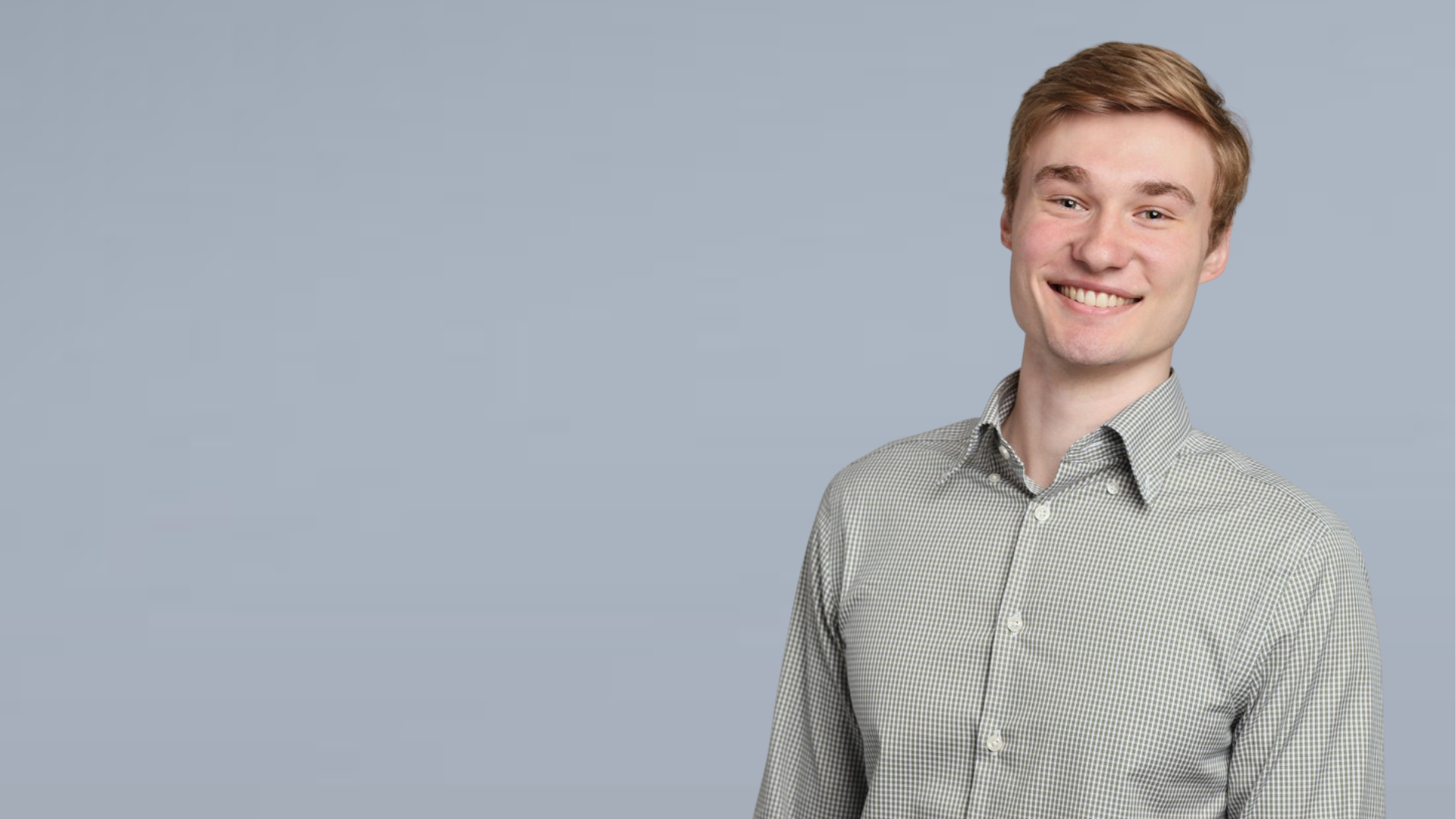 Headshot of Michael Brannan, smiling, wearing a gray button-down shirt.